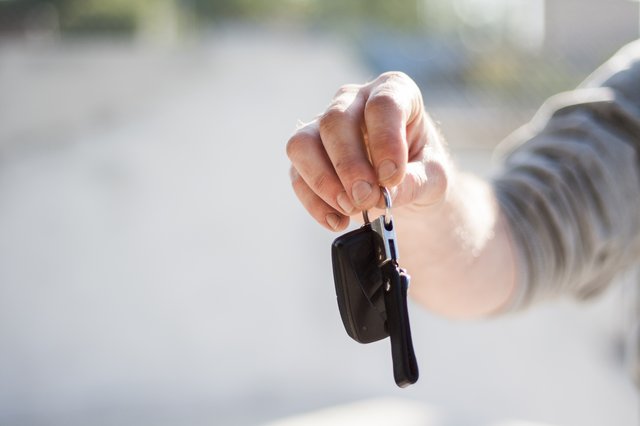 a persons hand holding up car keys