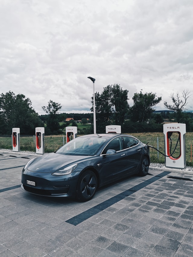 model 3 tesla parked at a tesla super charger.