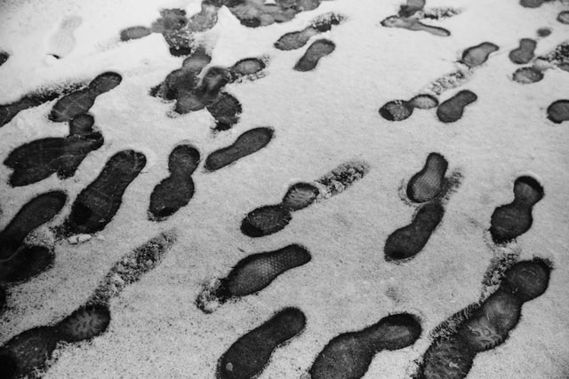 light snow on the ground. Bootprints in the snow.
